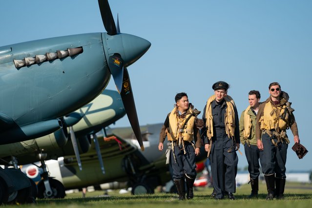 Spirit of Britain living history group stand by a Supermarine Spitfire during the annual Duxford Summer Air Show at IWM Duxford in Cambridgeshire on Sunday, June 25, 2023. This year marks the 50th anniversary of the first air show at Duxford. (Photo by Joe Giddens/PA Images via Getty Images)