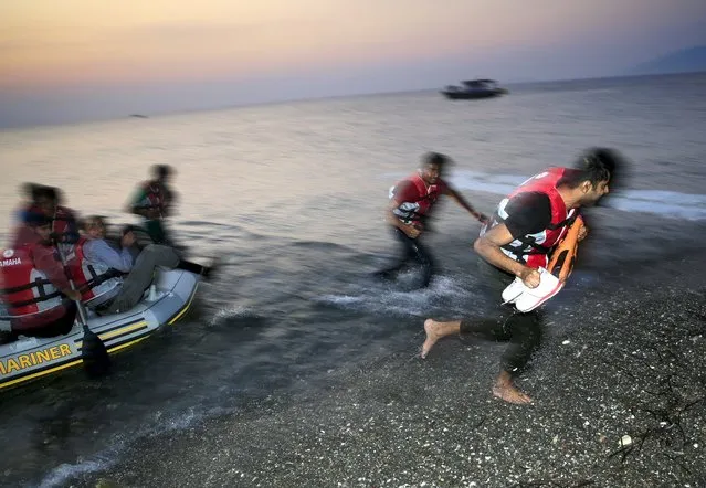 Pakistani migrants run in panic off a dinghy as they arrive at a beach on the Greek island of Kos, after crossing a part of the Aegean sea from Turkey, August 10, 2015. (Photo by Yannis Behrakis/Reuters)