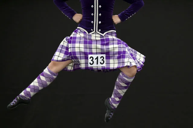 A competitor takes part in a Highland Country Dancing competition on Glasgow Green as part of the World Pipe Band Championships in Glasgow on August 12, 2017. (Photo by Andy Buchanan/AFP Photo)