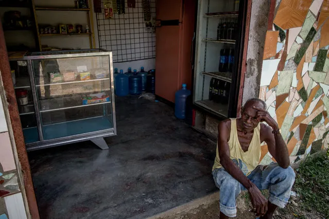 A man rest in front a local store in Barlovento, Venezuela on June 22, 2016. The store it's not receiving food since January forcing the people go to other bigger towns or even Caracas. (Photo by Alejandro Cegarra/The Washington Post)
