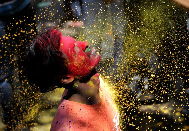 Locals apply colored powder on each other during Holi festival celebrations in Kolkata, Eastern India, 09 March 2020. Holi is an ancient Indian festival also known as the “Festival of Color”, held to mark the arrival of spring. (Photo by Piyal Adhikary/EPA/EFE)