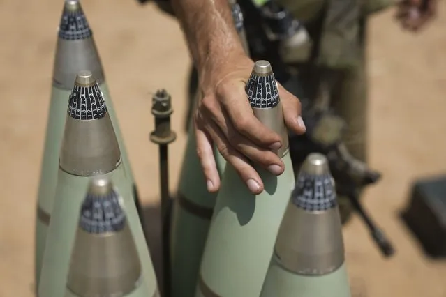 An Israeli soldier from the artillery unit loads a tank shell at the Israeli Gaza border, Saturday, August 6, 2022. Israeli jets pounded militant targets in Gaza as rockets rained on southern Israel, hours after a wave of Israeli airstrikes on the coastal enclave killed at least 11 people, including a senior militant and a 5-year-old girl. The fighting began with Israel's dramatic targeted killing of a senior commander of the Palestinian Islamic Jihad continued into the morning Saturday, drawing the sides closer to an all-out war. (Photo by Ariel Schalit/AP Photo)