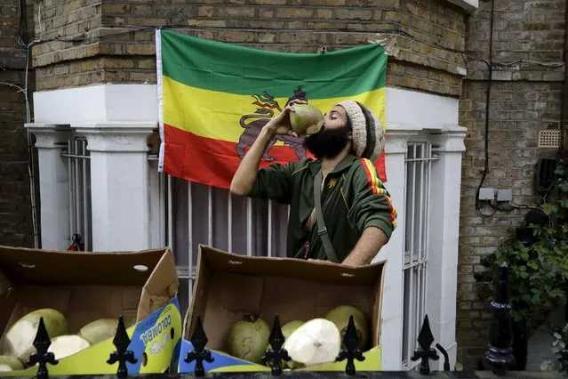 A man drinks from a coconut at the Notting Hill Carnival in London, Britain, August 30, 2015. (Photo by Kevin Coombs/Reuters)