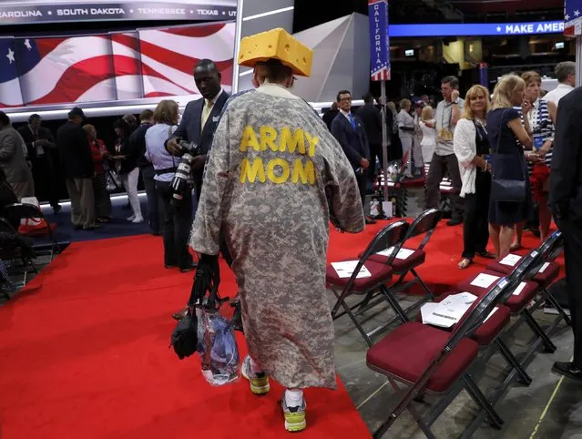 A delegate wearing an “Army Mom” camouflage coat and a Wisconsin "cheese head" hat walks across the convention floor before the start of the final session of the Republican National Convention in Cleveland, Ohio, U.S. July 21, 2016. (Photo by Brian Snyder/Reuters)