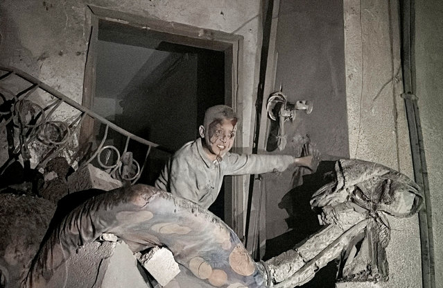 A child looks on following an Israeli strike at a post office where people were sheltering, in Nuseirat in central Gaza Strip, on December 12, 2024. (Photo by Khamis Said/Reuters)