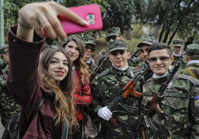 A woman takes a group photograph before the swearing in ceremony for the military students, in Bucharest, Romania, Wednesday, October 25, 2017. (Photo by Vadim Ghirda/AP Photo)