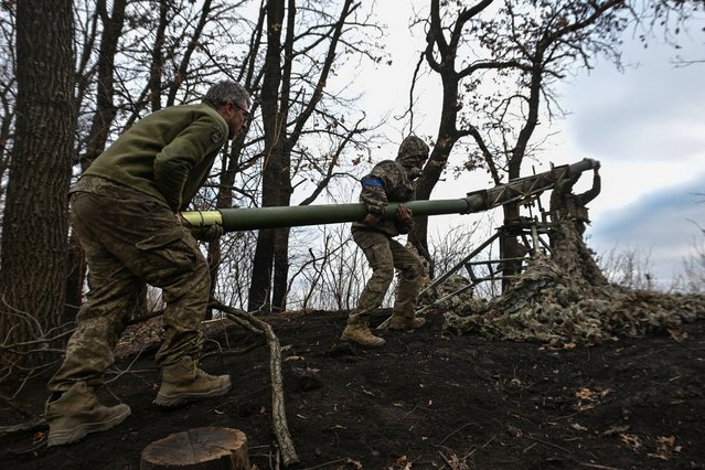 Servicemen of the 110th Territorial Defence Brigade of the Ukrainian Armed Forces load a rocket into a Grad-P Partizan launcher before firing towards Russian troops, at the frontline in Zaporizhzhia region, Ukraine, on January 21, 2025. (Photo by Reuters/Stringer)