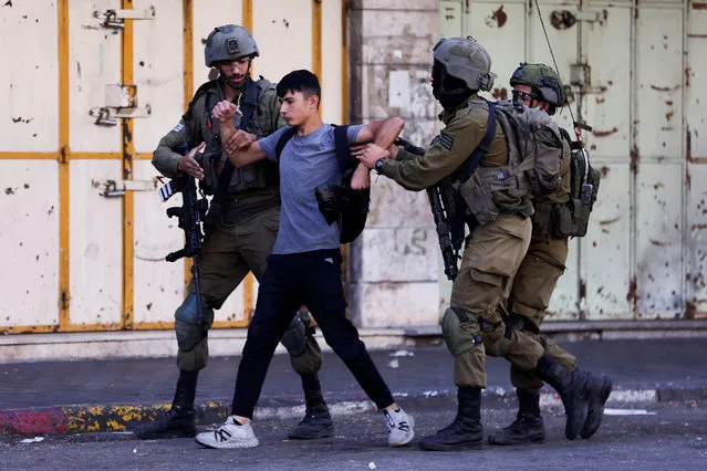 Israeli troops detain a man during a Palestinian protest over the killing of Palestinian gunmen in an Israeli raid on Wednesday, in Hebron in the Israeli-occupied West Bank on September 29, 2022. (Photo by Mussa Qawasma/Reuters)