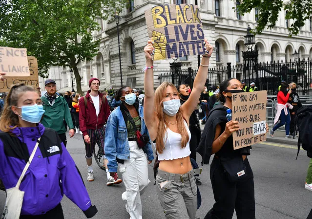 Demonstrators hold up signs as they march during a Black Lives Matter protest in London, following the death of George Floyd who died in police custody in Minneapolis, London, Britain, June 12, 2020. (Photo by Dylan Martinez/Reuters)
