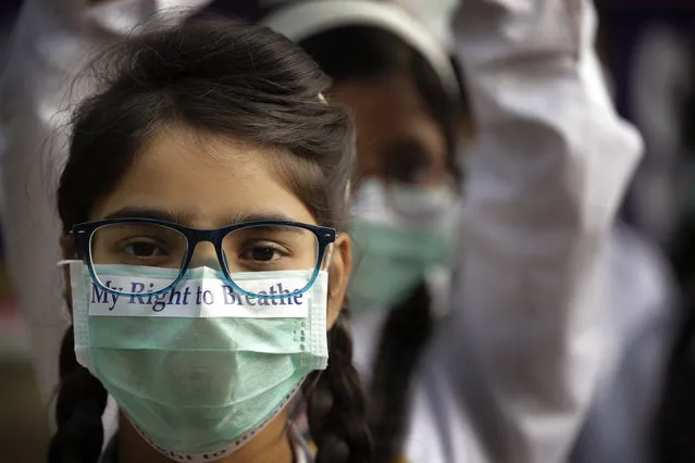 School children take out march to express their distress on the alarming levels of pollution in the city, in New Delhi, India, Wednesday, November 15, 2017. Thick smog has constricted India's capital this week, smudging landmarks from view and leaving residents frustrated at the lack of meaningful action by authorities. The air was the worst it has been all year in New Delhi, with microscopic particles that can affect breathing and health spiking to 75 times the level considered safe by the World Health Organization. (Photo by Manish Swarup/AP Photo)