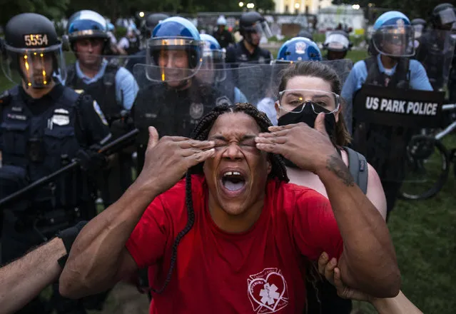 A woman reacts to being hit with pepper spray as protesters clash with U.S. Park Police after they attempted to pull down the statue of Andrew Jackson in Lafayette Square near the White House on June 22, 2020 in Washington, DC. Protests continue around the country over the deaths of African Americans while in police custody. (Photo by Tasos Katopodis/Getty Images)