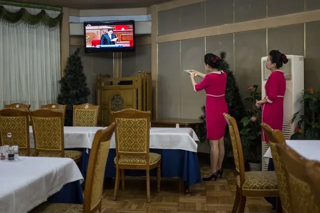 A hostess adjusts the volume of a television broadcast showing a speech by North Korean leader Kim Jong-Un at a restaurant at the Yanggakdo hotel in Pyongyang on May 6, 2016. (Photo by Ed Jones/AFP Photo)