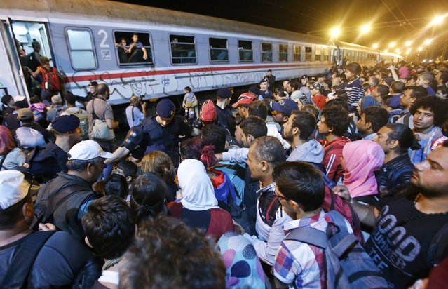 Migrants try to enter a train at a train station in Tovarnik, Croatia, September 18, 2015. (Photo by Antonio Bronic/Reuters)