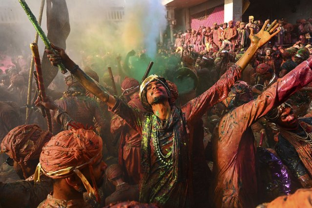 Villagers from Barsana and Nandgaon smeared with colors sing and dance as they participate Lathmar Holi at Nandagram temple in Nandgoan village, 115 kilometers (70 miles) south of New Delhi, India, Sunday March 9, 2025. (Photo by AP Photo)