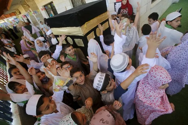 Palestinian children take part in a re-enactment of the annual haj pilgrimage to Mecca, at their school in the West Bank city of Nablus September 22, 2015. (Photo by Abed Omar Qusini/Reuters)