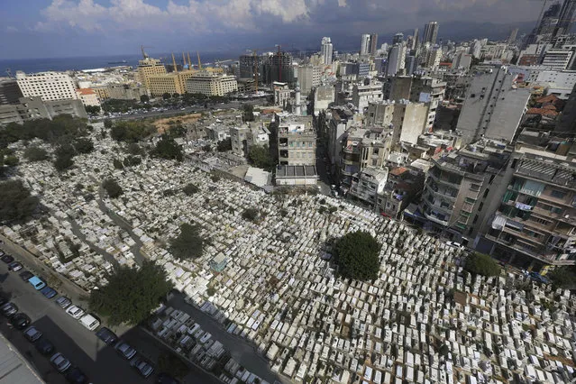 This Oct. 14, 2014, photo shows hundreds of graves at the overcrowded Bashoura cemetery for Muslim Sunnis in Beirut, Lebanon. The congested city of more than one million is cramped with cemeteries wedged into residential areas, increasingly forcing families to bury several members of the same family in one grave. Available land plots are extremely scarce and what is left is being used by developers to build luxury office towers and apartments. (AP Photo/Hussein Malla)