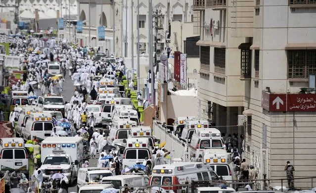 Saudi ambulances arrive with pilgrims who were injured in a stampede at an emergency hospital in Mina, near the holy city of Mecca, on the first day of Eid al-Adha on September 24, 2015. At least 310 people were killed and hundreds wounded during a stampede at the annual hajj in Saudi Arabia, in the second tragedy to strike the pilgrims this year. (Photo by Mohammed Al-Shaikh/AFP Photo)