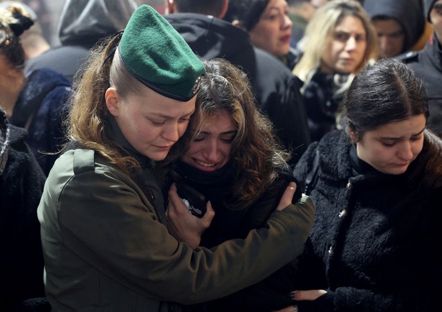 Friends and family mourn Israeli military reservist Sergeant First Class Nicholas Berger, who was killed in the southern Gaza Strip amid the ongoing ground operation of the Israeli army against Palestinian Islamist group Hamas, at his funeral at the Mount Herzl military cemetery in Jerusalem on January 24, 2024. (Photo by Ronen Zvulun/Reuters)
