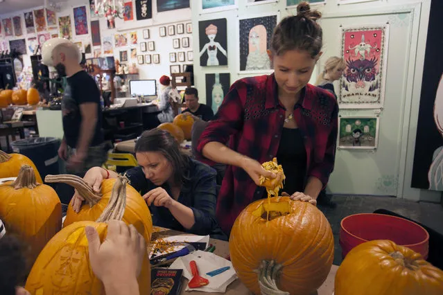 A workshop attendee pulls out innards from his pumpkin at Cotton Candy Machine in Brooklyn, N.Y. on October 18, 2014. (Photo by Siemond Chan/Yahoo Finance)