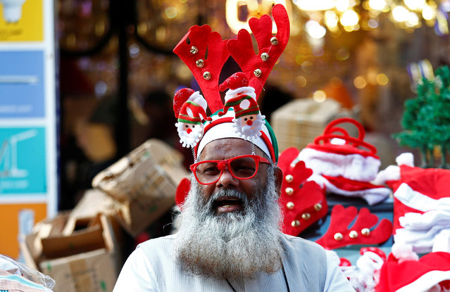 A vendor sells Christmas goodies on a street in Mumbai, December 14, 2017. (Photo by Shailesh Andrade/Reuters)