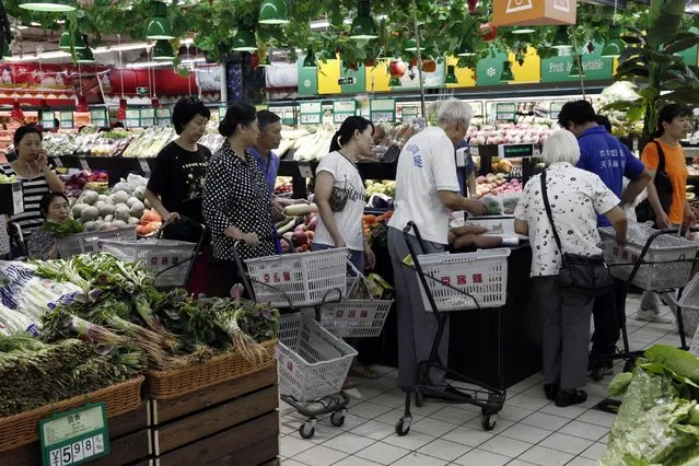 Customers queue to pay for groceries at a supermarket in Beijing, China, 09 September 2016. China's consumer price index, which is a factor in inflation, rose 1.3 per cent year-on-year in August, according to figures released by the National Bureau of Statistics on 09 September. (Photo by Rolex Dela Pena/EPA)