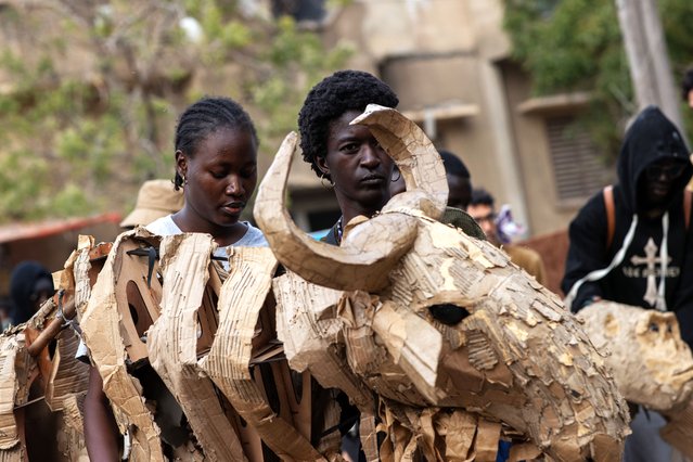 Puppeteers work with “The Herds”, animated life-size animals puppets made of recycled materials, in Dakar, Senegal, 25 April 2025. (Photo by Jerome Favre/EPA/EFE)