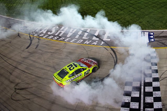 Ryan Blaney, driver of the #12 Menards/Cardell Cabinetry Ford, celebrates with a burnout after winning the NASCAR Cup Series Cracker Barrel 400 at Nashville Superspeedway on June 01, 2025 in Lebanon, Tennessee. (Photo by James Gilbert/Getty Images)