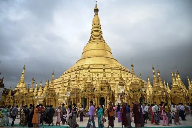 Buddhist devotees gather around the Shwedagon Pagoda during the Warso Full Moon Festival in Yangon on July 12, 2022. (Photo by AFP Photo/Stringer)