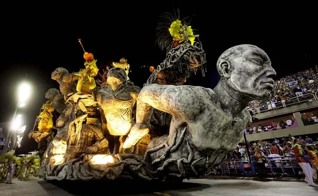 Dancers perform atop a float during the Inocentes de Belford Roxo samba school parade at the Sambadrome during carnival celebrations in Rio de Janeiro. (Photo by Hassan Ammar/Associated Press)