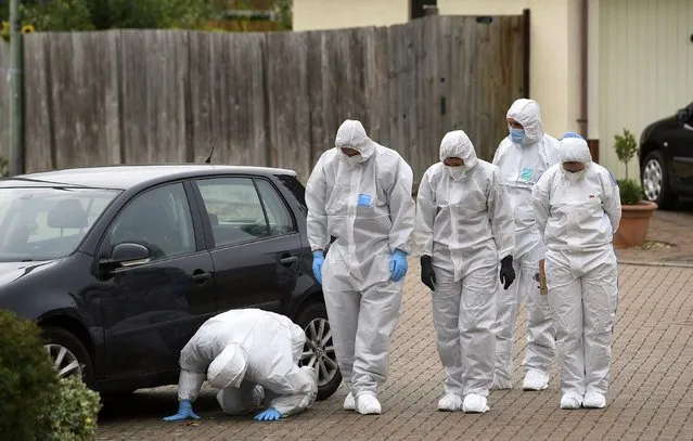 Police officers conduct a search in Kesgrave, England, Monday September 7, 2020, where a 15-year-old student from Kesgrave High School was shot just after 8.40am this morning. British police said a teenager in eastern England has been arrested in connection with the shooting on Monday of a 15-year-old boy on his way to school. (Photo by Joe Giddens/PA Wire via AP Photo)