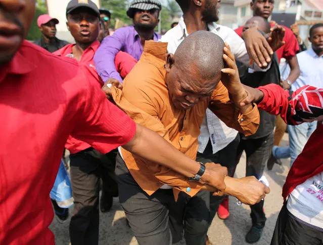 Opposition supporters beat a man accused of working for a Congolese intelligence service in front of an opposition party Union for Democracy and Social Progress (UDPS) office in Kinshasa, Democratic Republic of Congo, September 23, 2016. (Photo by Goran Tomasevic/Reuters)