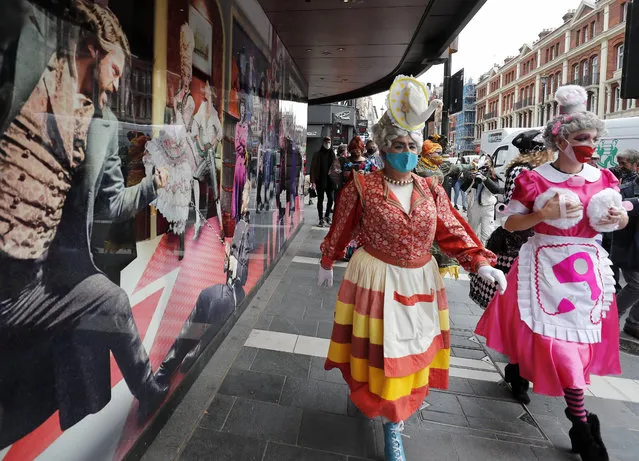 Actors dresses as panto dames march past a boarded up theatre on their way to Parliament to demand more support for the theatre sector amid the COVID-19 pandemic in London, Wednesday, September 30, 2020. (Photo by Frank Augstein/AP Photo)