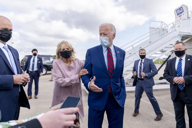 Jill Biden moves her husband, Democratic presidential candidate former Vice President Joe Biden, back from members of the media as he speaks outside his campaign plane at New Castle Airport in New Castle, Del., Monday, October 5, 2020, to travel to Miami for campaign events. (Photo by Andrew Harnik/AP Photo)