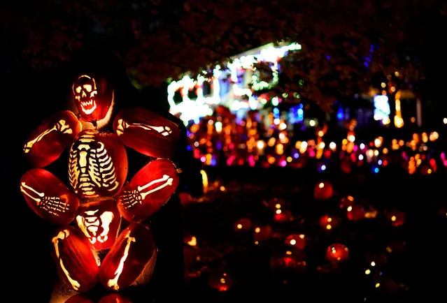 Halloween decorations are seen on display during the Great Jack O’Lantern Blaze in Croton-on-Hudson, New York on October 22, 2020, featuring over 7,000 hand-carved, illuminated pumpkins set against the mysterious backdrop of Van Cortlandt Manor’s 17th-century buildings and riverside landscape. Croton-on-Hudson, a quaint village an hour north of New York that's thrived thanks to a tale written some 200 years ago, is holding its annual Halloween bash – with the election and the pandemic lending an extra dose of chills The October 31st holiday is an industry of its own in this picturesque corner of the Hudson River Valley. (Photo by Timothy A Clary/AFP Photo)