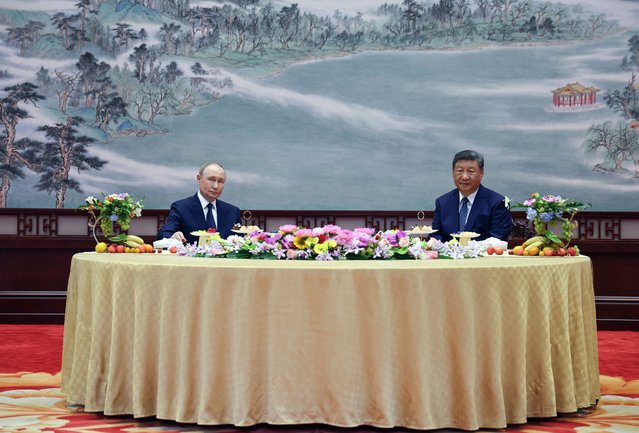 In this pool photograph distributed by the Russian state agency Sputnik, Russia's President Vladimir Putin (L) and China's President Xi Jinping attend a meeting at The Great Hall of the People in Beijing on September 2, 2025. (Photo by Alexander Kazakov/AFP Photo)