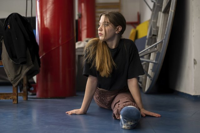 Ukrainian refugee circus student Mariia Lysytska stretching in a training room in Budapest, Hungary, Monday, February 13, 2023. More than 100 Ukrainian refugee circus students, between the ages of 5 and 20, found a home with the Capital Circus of Budapest after escaping the embattled cities of Kharkiv and Kyiv amid Russian bombings. (Photo by Denes Erdos/AP Photo)