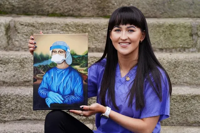 Chloe Slevin, a trainee nurse and INMO representative based in Dublin, with her painting Corona Lisa, which reimagines Leonarda Da Vinci's Mona Lisa in full PPE on January 23, 2022. (Photo by Brian Lawless/PA Images via Getty Images)