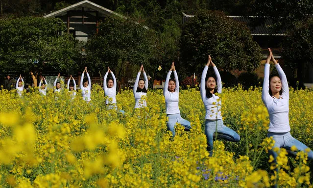 Yoga enthusiasts practise at Yellow Dragon Cave in Hunan, Zhangjiajie, China on March 25, 2018. (Photo by Xinhua/Barcroft Images)