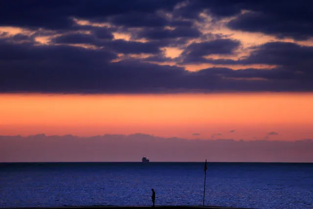 A fisherman stands on a breakwater along the Beirut coastline as the sun sets over the Mediterranean Sea, Lebanon, Wednesday, October 14, 2015. (Photo by Hassan Ammar/AP Photo)