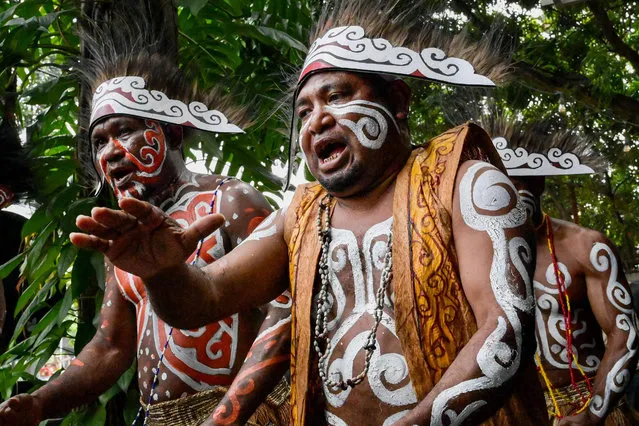 Men from Indonesia's Papua province sing a Wor song (an invitation to visit) during the Suara Jernih Papua (Papua's Clear Voice) festival in collaboration with Greenpeace, in Jakarta on March 17, 2023, held as part of a campaign asking the government to preserve Papuan forests as a solution to avoid climate crisis. (Photo by Bay Ismoyo/AFP Photo)