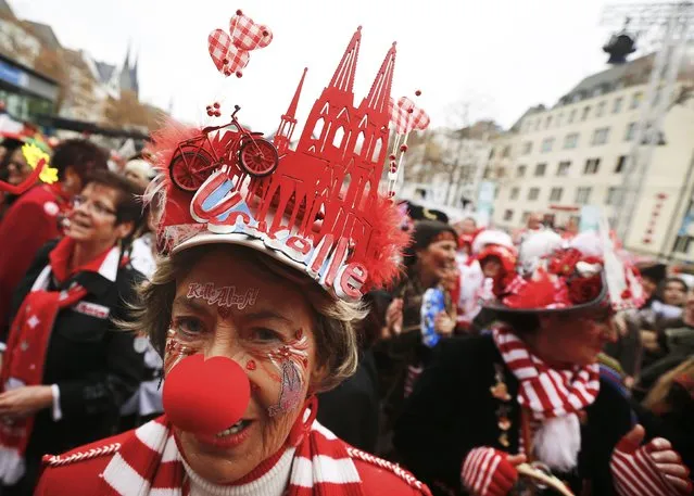 A carnival reveller celebrates the start of the carnival season in Cologne November 11, 2015. (Photo by Wolfgang Rattay/Reuters)
