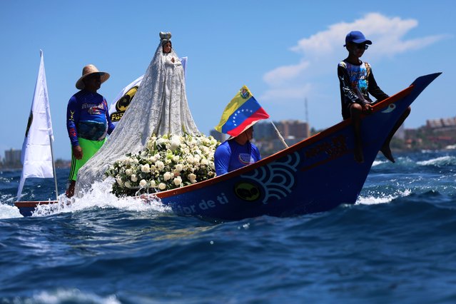 Participants aboard a boat join the maritime procession during the celebration of the Virgin of the Valley Day on Margarita Island, Venezuela, 08 September 2025. Most of the participants were fishermen steering their “peneros”, as small boats are known in the country, decorated for the occasion with flowers, balloons, flags, and altars featuring Marian images dressed in handmade garments. (Photo by Miguel Gutierrez/EPA)