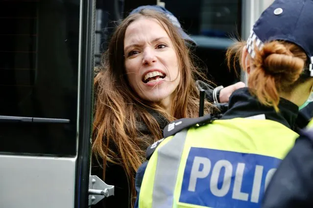 Police officers take into custody some protesters as members of StandUpX stage a protest against coronavirus (Covid-19) measures and vaccine in London, United Kingdom on October 24, 2020. (Photo by Hasan Esen/Anadolu Agency via Getty Images)