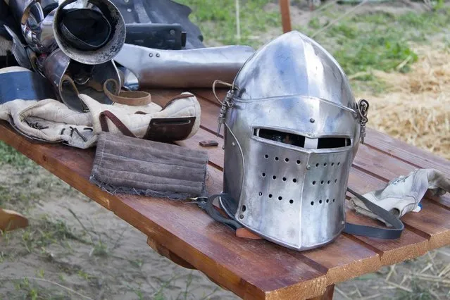 A helmet lays on a table during the “Battle of Nations” in Aigues-Mortes, southern France, Friday, May 10, 2013 where Middle Ages fans attend the historical medieval battle  competition. The championship will be attended by 22 national teams, which is twice the number it was last year. The battle lasts until May 12. (Photo by Philippe Farjon/AP Photo)