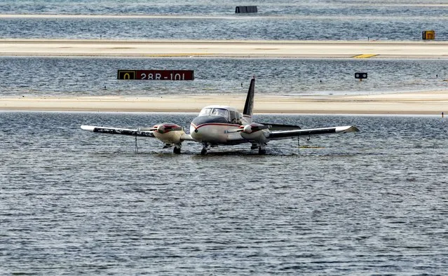 A small plane parked as the runway remains flooded from heavy rain at Fort Lauderdale-Hollywood International Airport on Thursday, April 13, 2023. (Photo by David Santiago/Miami Herald via AP Photo)