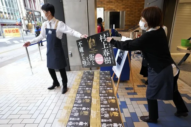 Shop clerks prepare to sell Japanese writer Haruki Murakami's new novel “The City and Its Uncertain Walls” on the first day for sale at Kinokuniya bookstore in Shinjuku district early Thursday, April 13, 2023, in Tokyo. (Photo by Eugene Hoshiko/AP Photo)