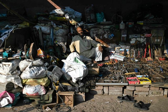 A vendor waits for customers at a roadside hardware shop in the old quarters of Delhi on November 5, 2025. (Photo by Arun Sankar/AFP Photo)