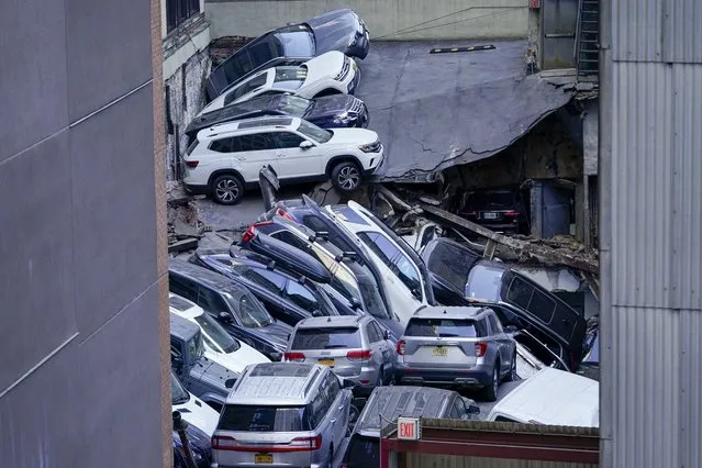 Cars are seen piled on top of each other at the scene of a partial collapse of a parking garage in the Financial District of New York, Tuesday, April 18, 2023, in New York. (Photo by Mary Altaffer/AP Photo)