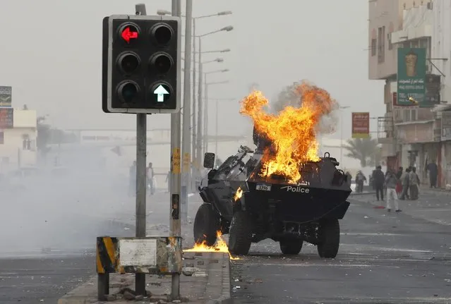 A Molotov cocktail which was thrown by protesters explodes on a riot police armoured personnel carrier at a highway in the village of Sitra, south of Manama, January 9, 2015. (Photo by Hamad I. Mohammed/Reuters)