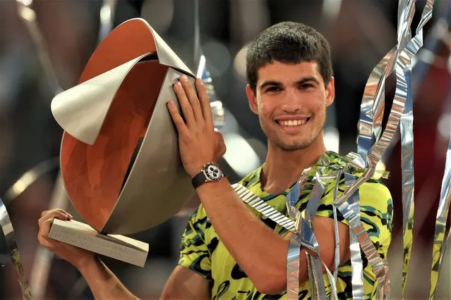 Spain's Carlos Alcaraz poses for pictures with the trophy after winning the 2023 ATP Tour Madrid Open tennis tournament singles final match against Germany's Jan-Lennard Struff at Caja Magica in Madrid on May 7, 2023. (Photo by Pierre-Philippe Marcou/AFP Photo)